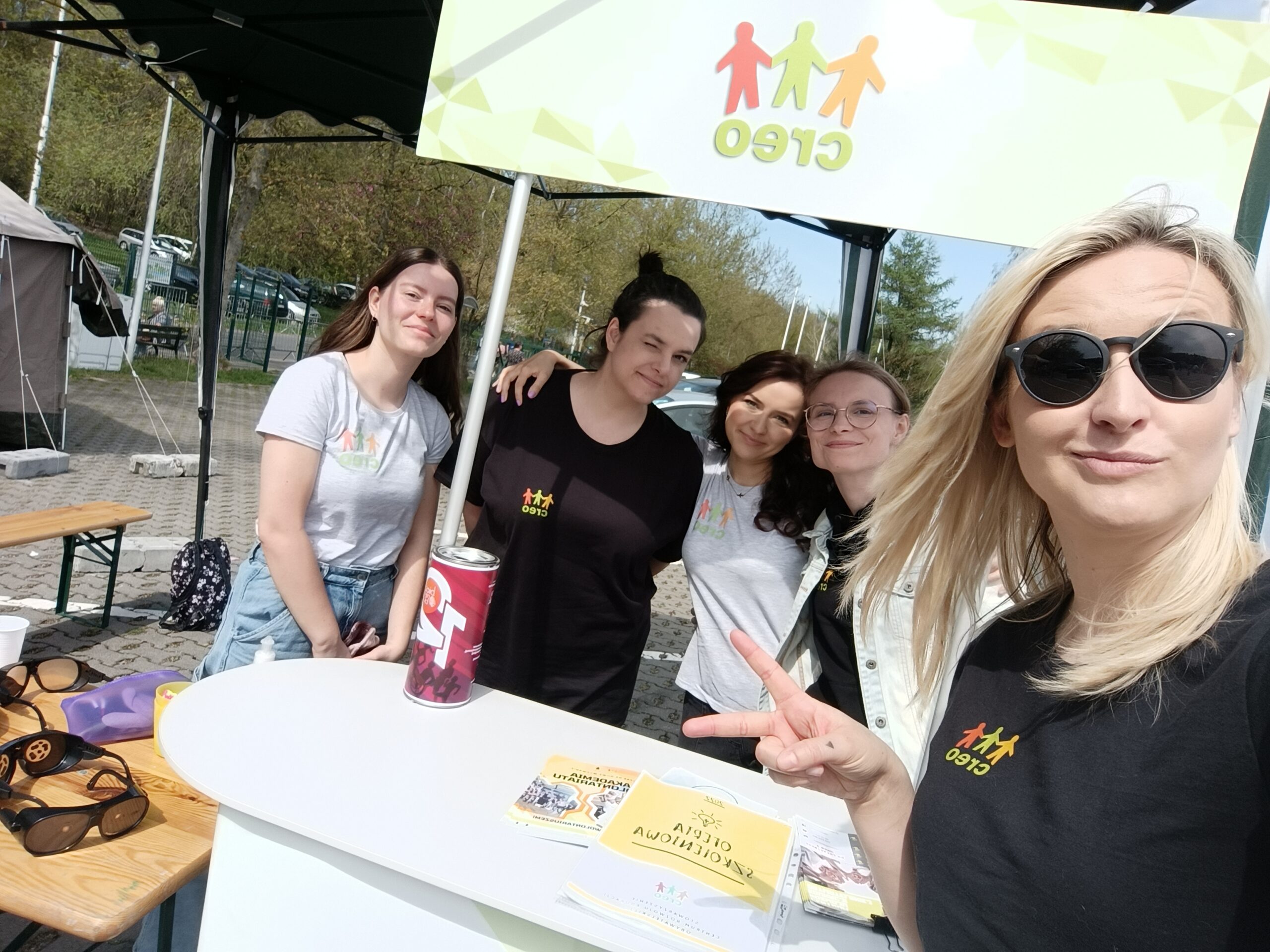 Grupa uśmiechniętych kobiet robi selfie przy stoisku CREO